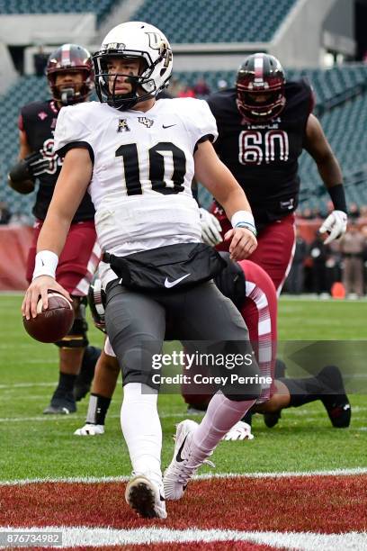 McKenzie Milton of the UCF Knights scores for a touchdown against the Temple Owls during the first quarter at Lincoln Financial Field on November 18,...