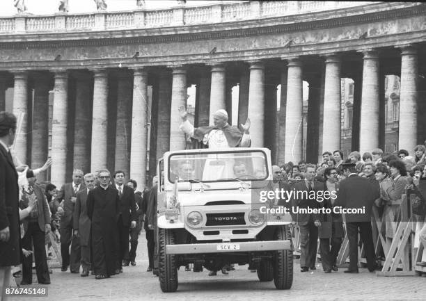 Pope John Paul II greets people at the Vatican City in 1979.