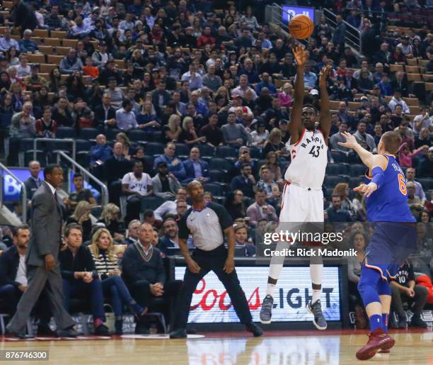 Toronto Raptors forward Pascal Siakam throws up a three point shot as New York Knicks forward Kristaps Porzingis comes out to defend. Toronto Raptors...