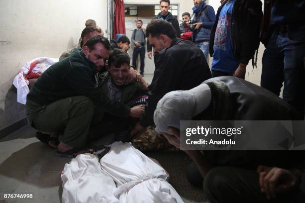 People cry near dead bodies of the victims at a sahra hospital after Assad regime's warcrafts carried out airstrikes over residential areas of Kafr...