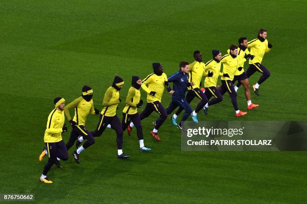 Tottenham Hotspur's players warm up during a training session on the eve of the Champion's League Group H football match Borussia Dortmund against...