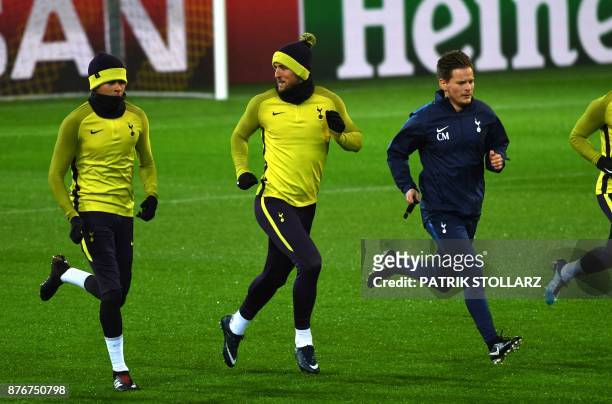 Tottenham Hotspur's players including English striker Harry Kane warm up during a training session on the eve of the Champion's League Group H...