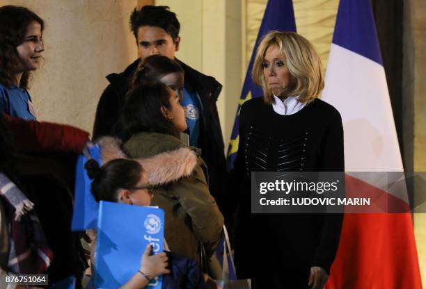 French President's wife Brigitte Macron speaks with children accompanied by the United Nations' agency United Nations Children's Fund for a meeting...