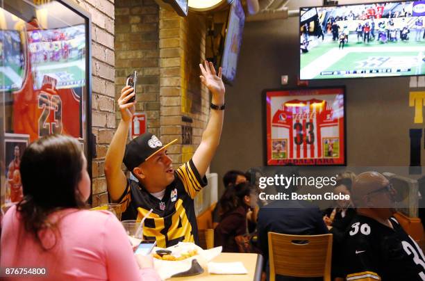 Mexican Pittsburgh Steelers fan cheers after his team scored a touchdown against the Tennessee Titans as fans watch the Steelers game at a Buffalo...