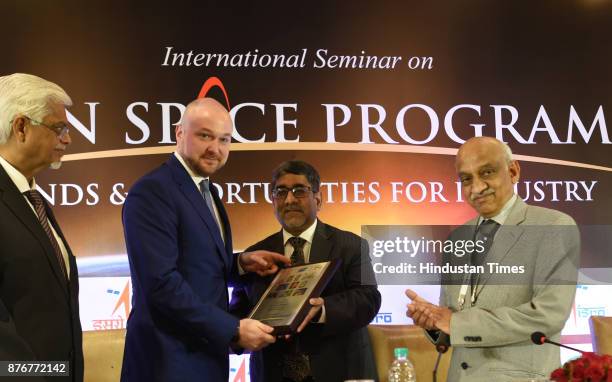 Kiran Kumar, Secy. Department of Space, Chairman - ISRO and Space Commission along with others presenting the memento to Russian official and during...