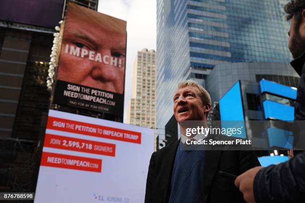 Philanthropist Tom Steyer stands in front of one of the billboards he has funded in Times Square calling for the impeachment of President Donald...