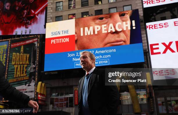Philanthropist Tom Steyer stands in front of one of the billboards he has funded in Times Square calling for the impeachment of President Donald...