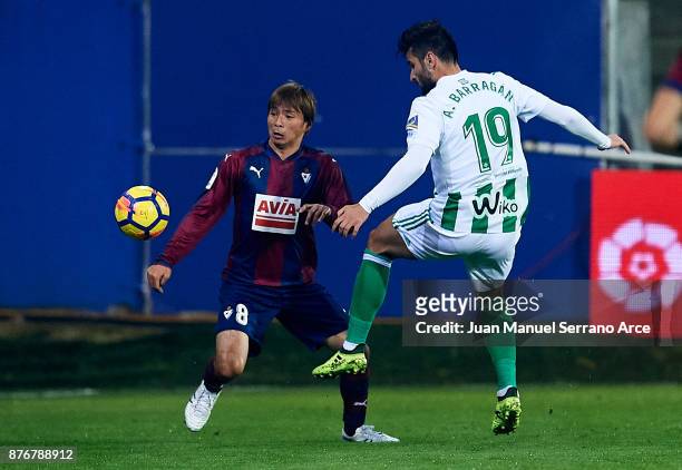 Takashi Inui of SD Eibar duels for the ball with Antonio Barragan of Real Betis during the La Liga match between Eibar and Real Betis at Estadio...