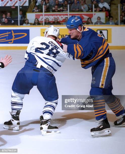 Rob Ray of the Buffalo Sabres battles with Tie Domi of the Toronto Maple Leafs during NHL game action on February 10, 1996 at Maple Leaf Gardens in...