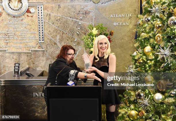 Singer Gwen Stefani is gifted a miniature replica of the The Empire State Building by Empire State Realty Trust, Inc CMO Audrey Pass before lighting...