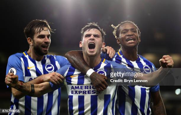 Pascal Gross of Brighton and Hove Albion celebrates scoring his side's first goal with Davy Propper and Gaetan Bong during the Premier League match...