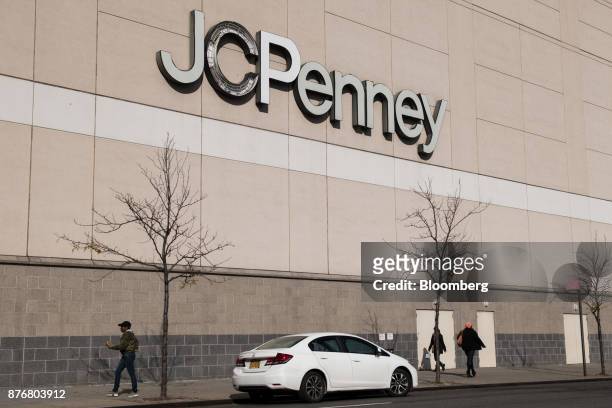 Pedestrians walk past a J.C. Penney Co. Store in the Queens borough of New York, U.S., on Monday, Nov. 20, 2017. Traditional retailers may be able to...