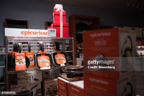 Kitchen pans hang on display for sale at a discounted price at a J.C. Penney Co. Store in the Queens borough of New York, U.S., on Monday, Nov. 20,...