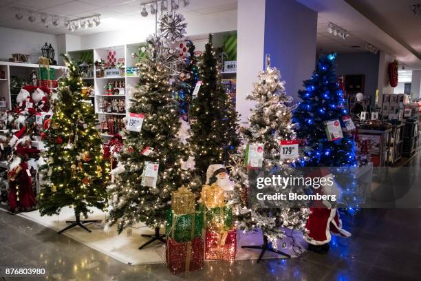 Christmas trees and holiday decorations sit on display for sale at a discounted price at a J.C. Penney Co. Store in the Queens borough of New York,...