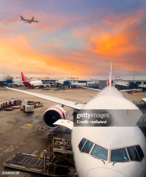 airplane parked at international airport - airport runway stock pictures, royalty-free photos & images