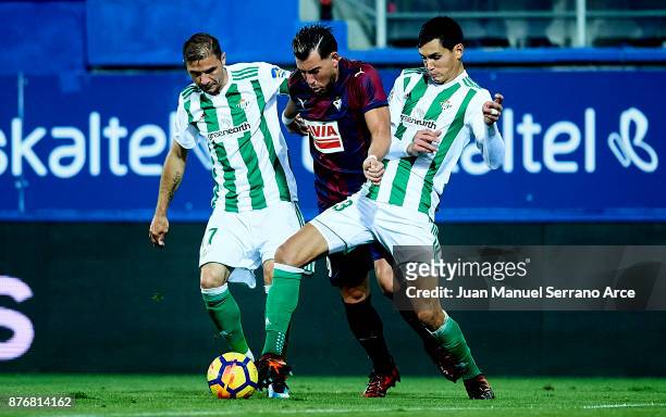 Sergi Enrich of SD Eibar duels for the ball with Joaquin Sanchez and Aissa Mandi of Real Betis during the La Liga match between Eibar and Real Betis...