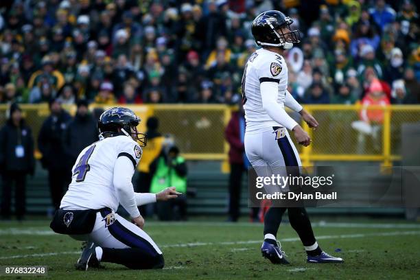 Justin Tucker of the Baltimore Ravens kicks a field goal as Sam Koch holds in the fourth quarter against the Green Bay Packers at Lambeau Field on...