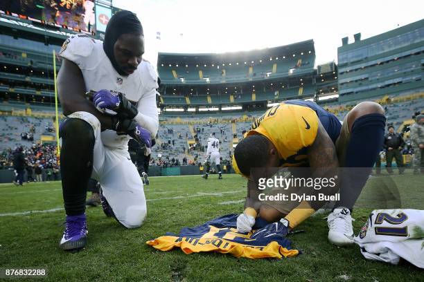 Ha Ha Clinton-Dix of the Green Bay Packers signs a uniform for C.J. Mosley of the Baltimore Ravens after the game at Lambeau Field on November 19,...