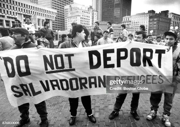 Group of local Salvadorans hold a sign during a vigil on Boston City Hall Plaza calling for the extension of the temporary protected status of...