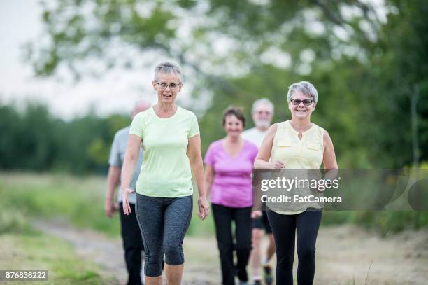 happy people - senior adult walking stock pictures, royalty-free photos & images