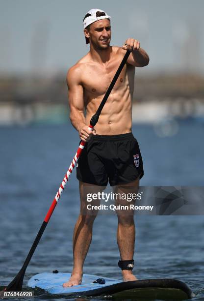 Luke Dunstan of the Saints does stand up paddleboarding during a St Kilda Saints AFL training session at Catani Gardens on November 21, 2017 in...