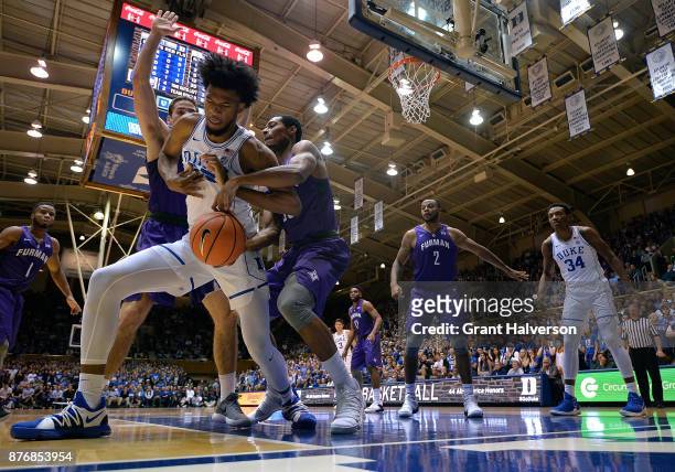 Marvin Bagley III of the Duke Blue Devils battles Andrew Brown and Daniel Fowler of the Furman Paladins for a loose ball during their game at Cameron...