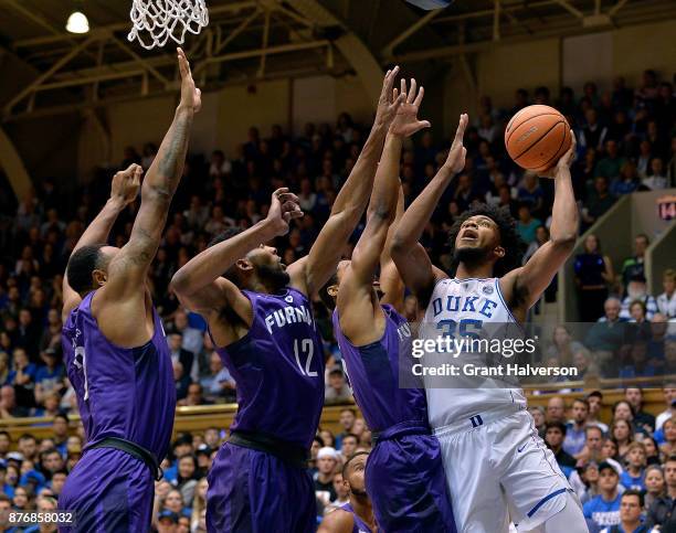 Marvin Bagley III of the Duke Blue Devils shoots over Jalen Williams, Andrew Brown and Daniel Fowler of the Furman Paladins during their game at...