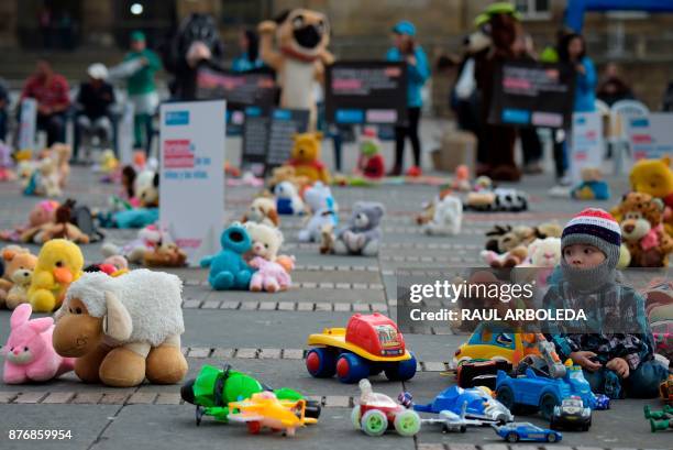 Toddler is pictured during an urban intervention at Bolivar square in Bogota to protest against child abuse, and to raise awareness on children's...