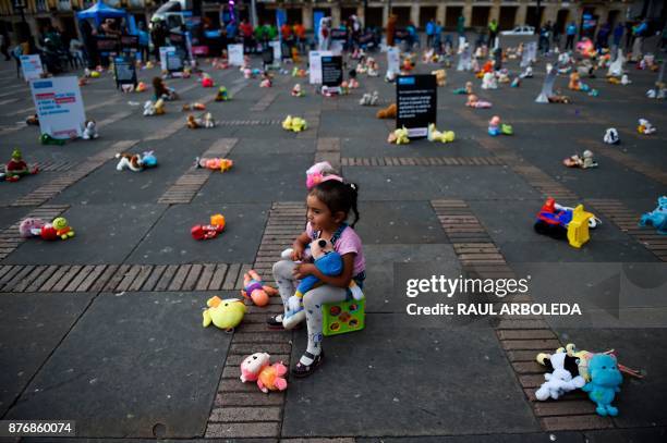 Little girl is pictured during an urban intervention at Bolivar square in Bogota to protest against child abuse, and to raise awareness on children's...