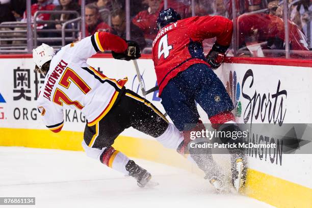 Mark Jankowski of the Calgary Flames and Taylor Chorney of the Washington Capitals collide in the second period at Capital One Arena on November 20,...