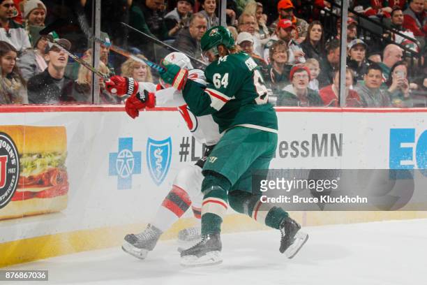 Mikael Granlund of the Minnesota Wild collides with John Moore of the New Jersey Devils during the game at the Xcel Energy Center on November 20,...