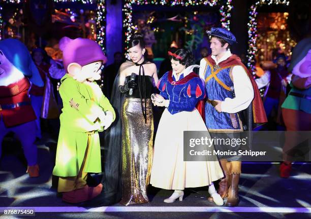 Actress and singer Sofia Carson, is joined by Snow White, The Prince and the Seven Dwarfs when she performs during the 2017 Saks Fifth Avenue Holiday...