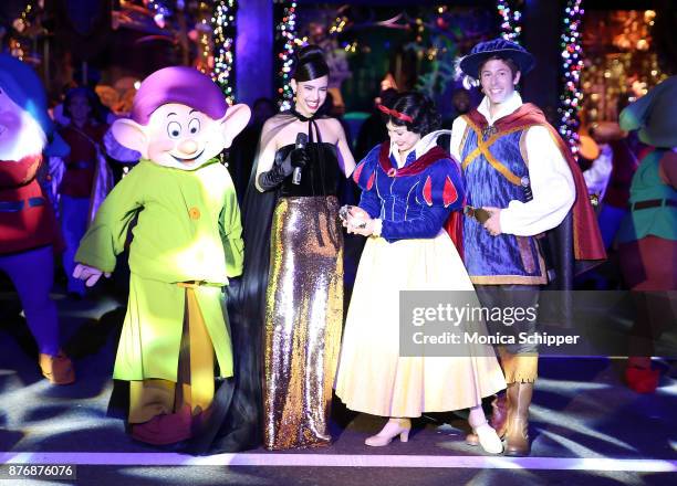 Actress and singer Sofia Carson, is joined by Snow White, The Prince and the Seven Dwarfs when she performs during the 2017 Saks Fifth Avenue Holiday...