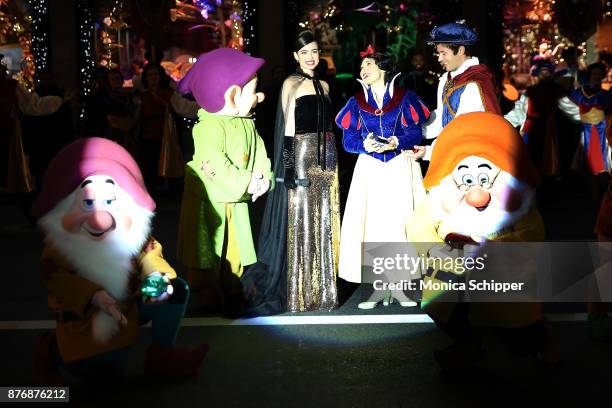 Actress and singer Sofia Carson, is joined by Snow White, The Prince and the Seven Dwarfs when she performs during the 2017 Saks Fifth Avenue Holiday...