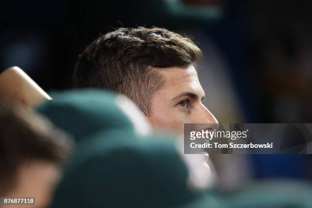 Jaycob Brugman of the Oakland Athletics holds a bat as he looks on from the dugout during MLB game action against the Toronto Blue Jays at Rogers...
