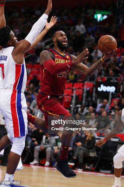 LeBron James of the Cleveland Cavaliers splits the defense of Stanley Johnson and Tobias Harris of the Detroit Pistons during the first half at...