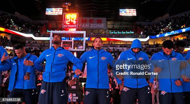 Oklahoma City Thunder join arms during the National Anthem before the start of their game against the San Antonio Spurs at AT&T Center on November...