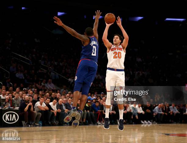 Doug McDermott of the New York Knicks shoots a three point shot as Sindarius Thornwell of the Los Angeles Clippers defends at Madison Square Garden...