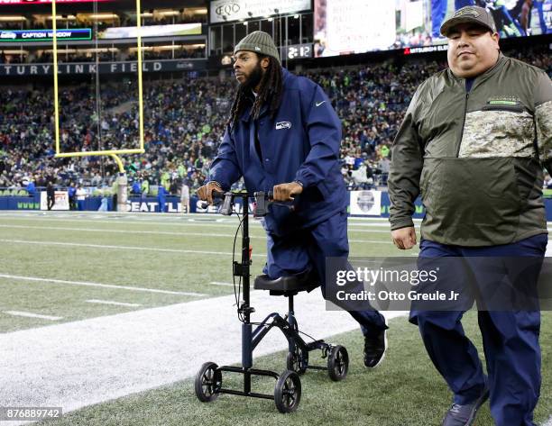 Cornerback Richard Sherman of the Seattle Seahawks wheels along the sidelines, out with an Achilles injury, during the game agains the Atlanta...