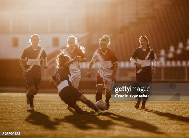 tackling the rival on woman's soccer match! - women's soccer stock pictures, royalty-free photos & images