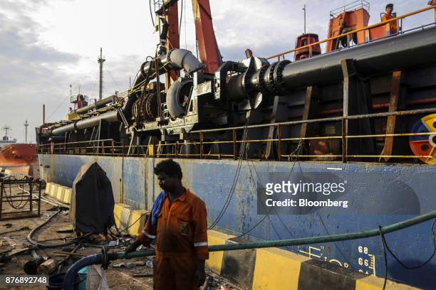 Worker labors as the Navayuga 2 dredger sits docked at Krishnapatnam Port in Krishnapatnam, Andhra Pradesh, India, on Saturday, Aug. 12, 2017. Growth...