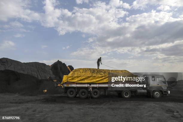 Workers secure a tarp on a truck laden with coal at Krishnapatnam Port in Krishnapatnam, Andhra Pradesh, India, on Monday, Aug. 11, 2017. Growth in...