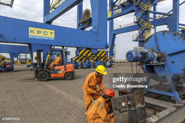 Employees repair a control panel next to a ganty crane at Krishnapatnam Port in Krishnapatnam, Andhra Pradesh, India, on Saturday, Aug. 12, 2017....