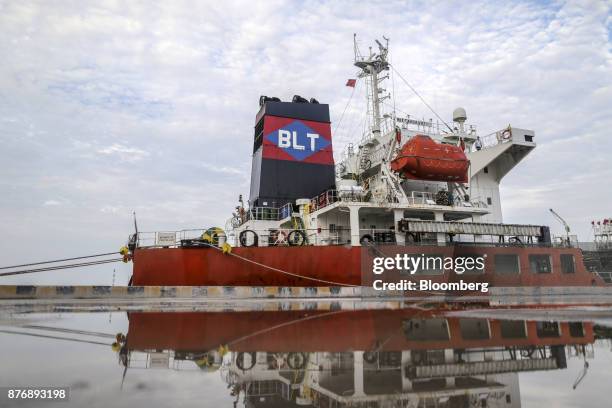 The Gandawati Tarawa tanker is reflected in a puddle while docked at Krishnapatnam Port in Krishnapatnam, Andhra Pradesh, India, on Saturday, Aug....