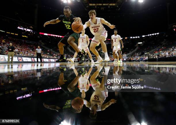 King McClure of the Baylor Bears competes with Ethan Happ of the Wisconsin Badgers for a loose ball during the game National Collegiate Basketball...