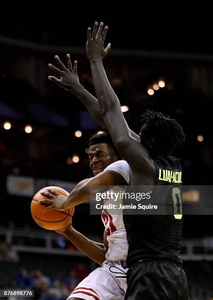 Khalil Iverson of the Wisconsin Badgers drives against Jo Lual-Acuil Jr. #0 of the Baylor Bears during the game National Collegiate Basketball Hall...