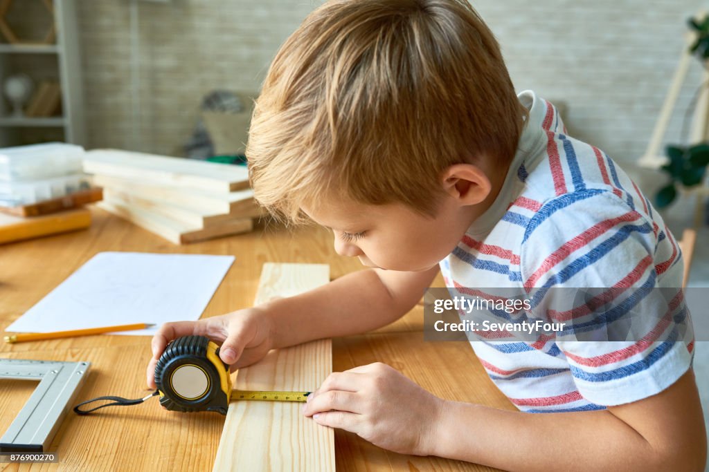 Cute Boy Working with Wood
