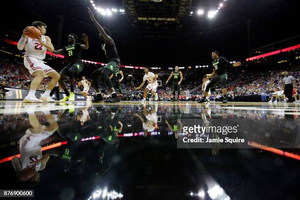 Ethan Happ of the Wisconsin Badgers controls the ball as Nuni Omot of the Baylor Bears defends during the game National Collegiate Basketball Hall Of...