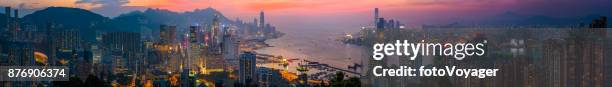 hong kong sunset skyscrapers panorama over victoria harbour kowloon china - kowloon walled city stock pictures, royalty-free photos & images