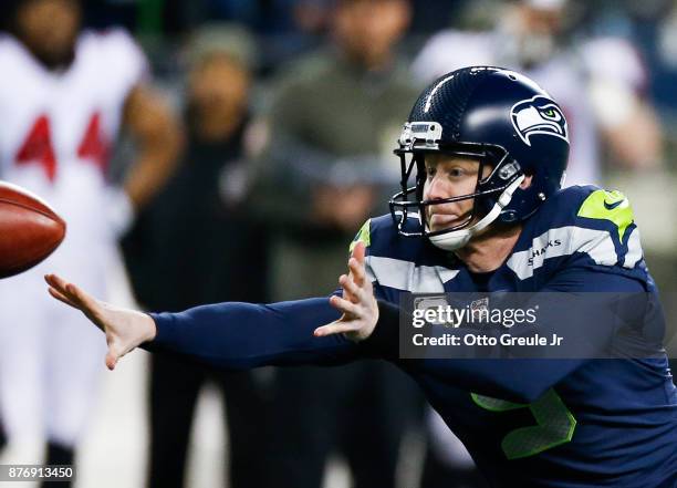 Punter Jon Ryan of the Seattle Seahawks tosses the ball to Luke Willson during a fake field goal attempt during the second quarter of the game...